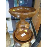 A turned yew wood fruit bowl on stand and two bowl dishes (3)