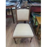 A pair of Edwardian walnut side chairs, with shaped top rails, padded backs and seats on square