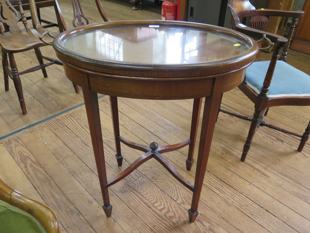 An Edwardian inlaid mahogany oval window table, with detachable glass tray, on square section