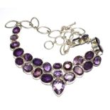 A large silver plated necklace set with amethyst colour stones