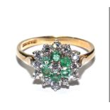 A 9 carat gold ring set with emeralds and cubic zirconia