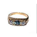 A 9 carat gold ring set with blue topaz and cubic zircon