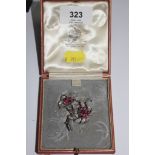 A diamond and ruby two headed flower brooch in fitted Carringtons of 130 Regent Street, London box