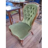 A mid Victorian walnut lady's chair, the button back and overstuffed seat on cabriole legs and