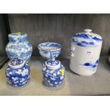 A pair of Chinese prunus design vases and covers, 11 cm high, four character mark to base, chips,