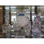 Four crystal glass decanters, with metal wine labels