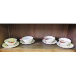 A vintage Suzie Cooper set of four art deco two handle bowls and saucers with polka dot and