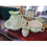 A late Victorian green and white washing table set, comprising wash bowl, water jug, chamber pot and