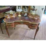 A 19th century French style kingwood and gilt metal mounted kidney shaped lady's desk, the leather