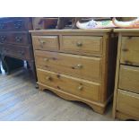 A low pine chest of drawers, the two short and two long drawers on bracket feet, 79 cm wide, 45 cm