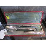 A cased silver knife, fork and spoon of mixed dates