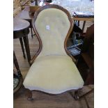 A Victorian mahogany lady's chair, the spoon shaped button back with low scroll arms on cabriole