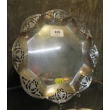 A silver dish with pierced border, on four feet, Sheffield 1932