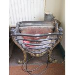 A cast iron fire basket, with brass finish acanthus scroll feet, 48 cm wide
