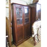 A mahogany bookcase, with twin glazed and panelled doors, 101 cm wide, 30 cm deep, 168 cm high