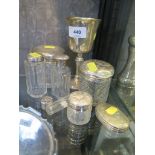 Seven silver lidded glass toilet bottles and a silver goblet