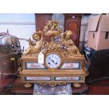 A 19th century French giltmetal and porcelain mounted mantel clock, the central floral urn flanked