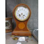 An Edwardian inlaid mahogany balloon mantel clock, the case with central patera, on brass ogee feet,