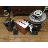 A blacked metal and brass magic lantern, various 16mm film, film cans and other movie related