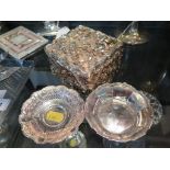 Two small silver dishes and a silver coloured jewellery box with cherub decoration