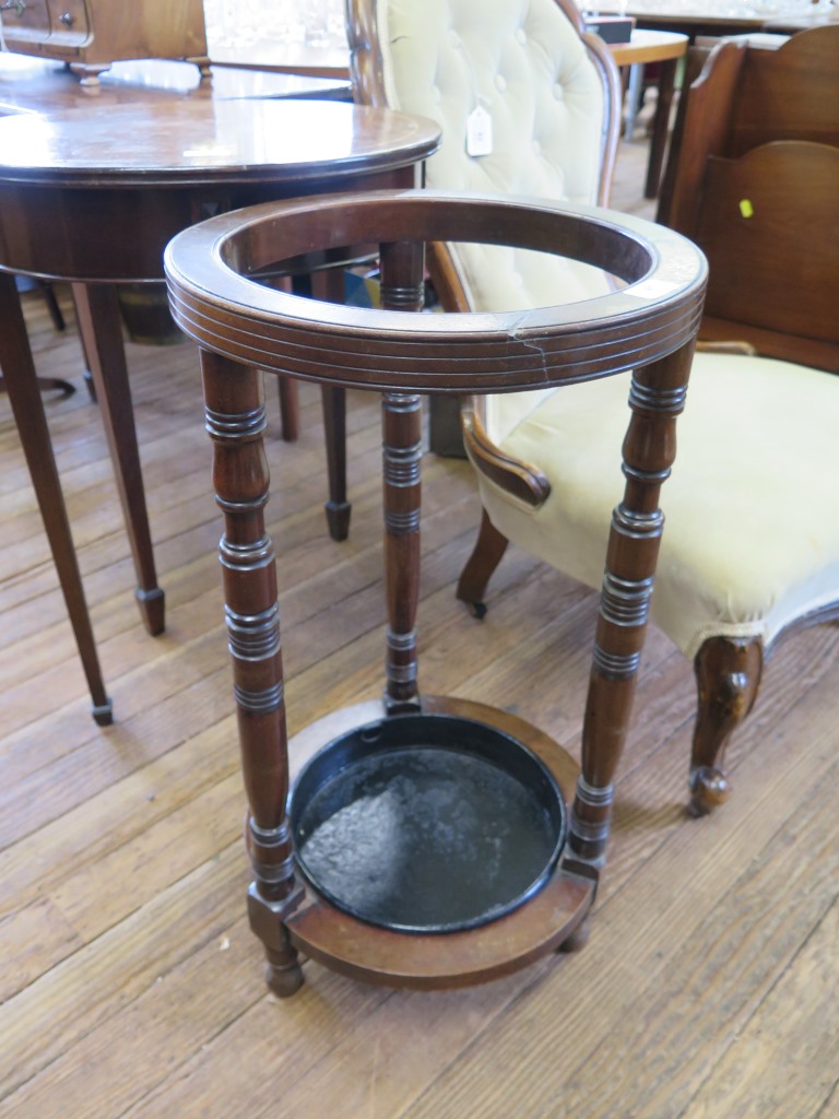 An Edwardian mahogany umbrella stand, cylindrical with ring turned supports, 37 cm diameter, 70 cm