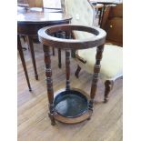 An Edwardian mahogany umbrella stand, cylindrical with ring turned supports, 37 cm diameter, 70 cm