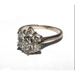 A fine seven stone diamond cluster ring set in white colour metal