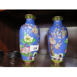 A pair of cloisonne vases, with magnolia and cherry blossom decoration, on stands, 18 cm high