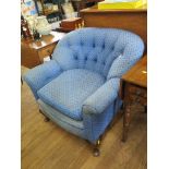 A 1920s blue button back upholstered arm chair with cabriole legs and pad feet