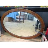 An Edwardian walnut line inlaid oval mirror, with bevelled plate, 102.5 x 71.5 cm