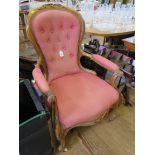 A Victorian walnut gentleman's armchair, the scroll carved top rail over a button back with scroll