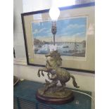 A pair of brass table lamps, in the form of the Marly horses after Coustou, total height 40 cm
