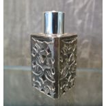 A square perfume bottle decorated in silver overlay
