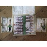 A boxed set of porcelain handled tea knives and forks by Royal Crown Derby, and two boxed Crown