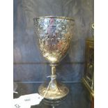 A silver plated goblet with embossed floral design to cup and foot