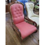 A Victorian mahogany rocking chair, the button back with scroll arms and curved rockers