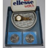 A ladies Ellesse wristwatch and two commemorative coins