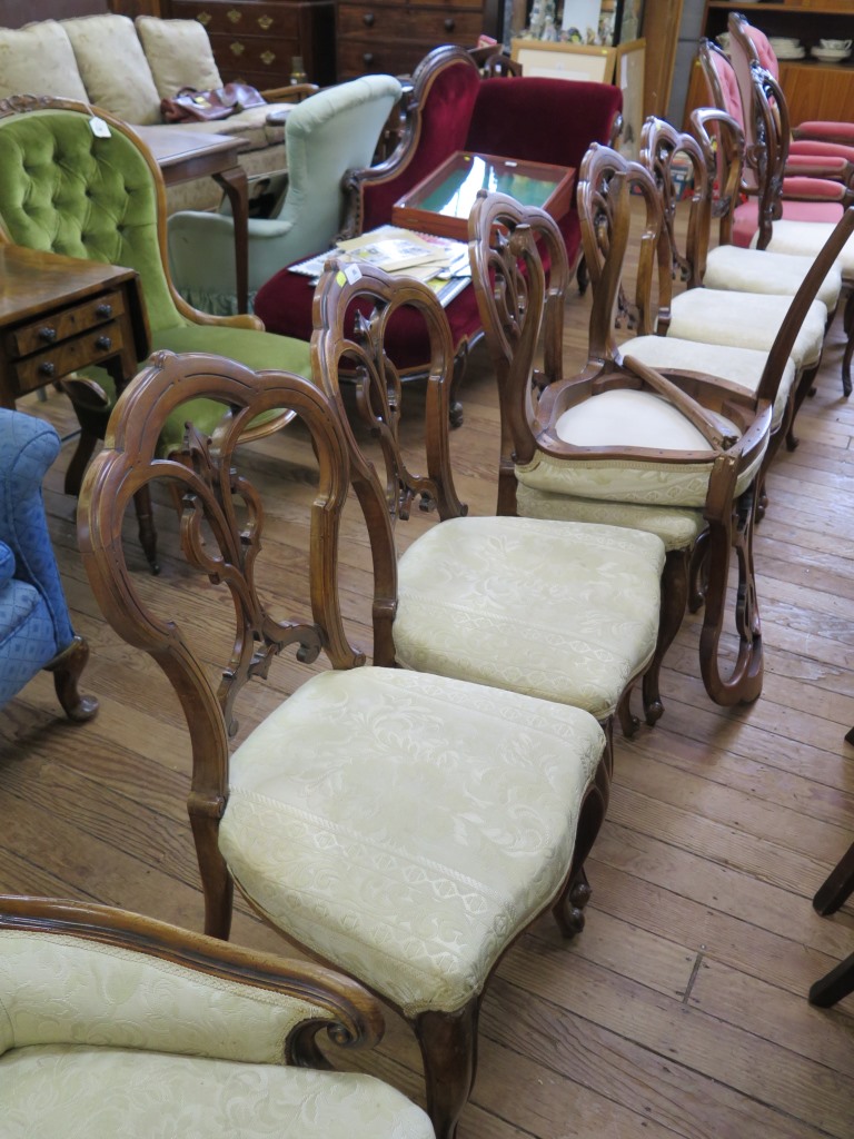 A set of six early Victorian walnut dining chairs, the trefoil interlaced backs on moulded