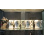 A set of seven Crown Devon tankards, each depicting a day of the week, 14 cm high, and a German