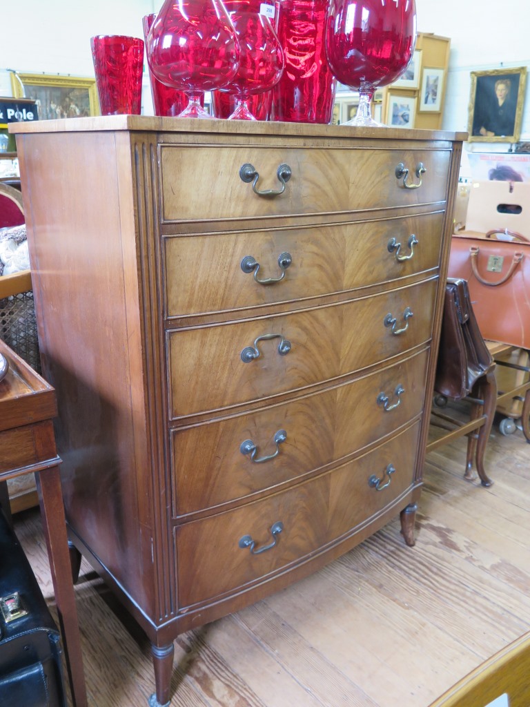 A George III style mahogany bow front chest of drawers, with five long graduated drawers, on