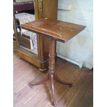 A George III mahogany reading stand, the adjustable slope on a turned stem with four outsplayed legs