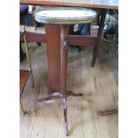 A marble top mahogany torchere stand, the oval top with brass gallery on an adjustable fluted stem