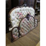 A Victorian mahogany bed head, the arched frame with foliate spray centre and button back