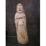 A Japanese ivory carving of Buddha playing the flute, circa 1890, 16 cm high