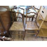 A pair of shaped ladderback bedroom chairs, with cane seats and cabriole legs (2)