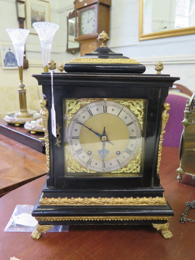 A George II style ebonised and gilt-metal bracket clock, the matted brass dial with scroll spandrels