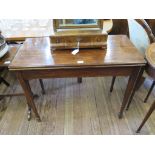 A late George III mahogany foldover tea table, the rectangular top on square tapering legs and spade