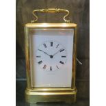 A brass carriage clock, inscribed Jules a Paris, with bevelled glass panels and inscribed enamel