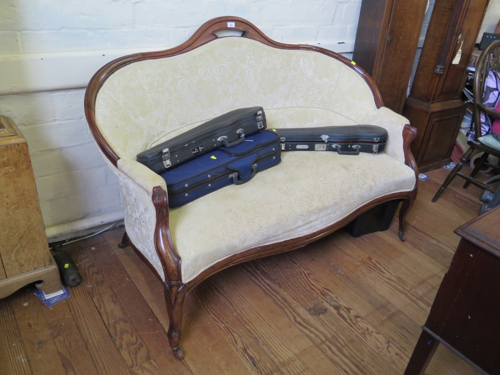 A 19th century continental two seat settee, the serpentine back and arms on cabriole legs with pot