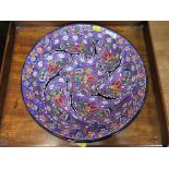 A Turkish profusely hand enamelled floral design Hors d'Ouvres dish with seven sections, 36 cm